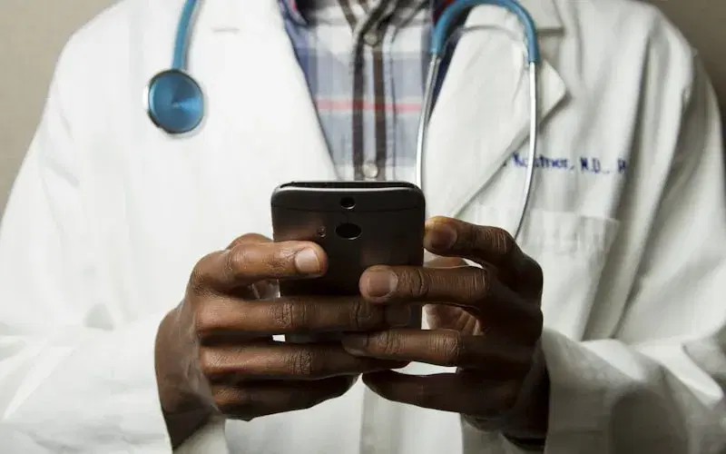 Healthcare field team coordinating hospital visits on a mobile device